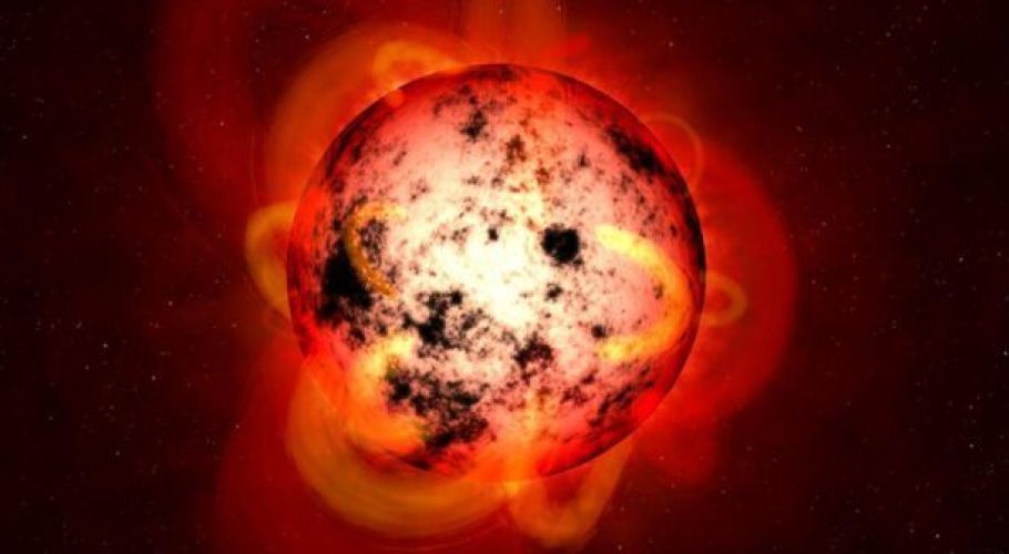 An illustration of an M-dwarf star covered in starspots. Cropped version of image from NASA/ESA/STScI/G. Bacon.