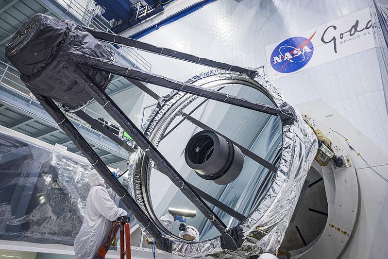   Optical Engineer Bente Eegholm performs and inspection of Roman's Primary mirror. This was taken shortly after it was lifted out of the shipping container  Photo Credit: NASA/Chris Gunn